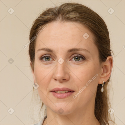 Joyful white adult female with medium  brown hair and green eyes