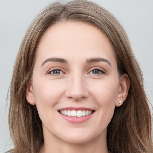 Joyful white young-adult female with long  brown hair and grey eyes