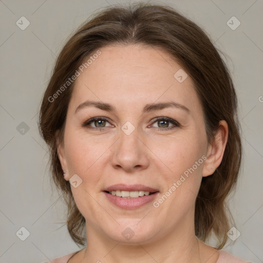 Joyful white adult female with medium  brown hair and green eyes