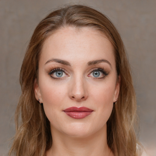 Joyful white young-adult female with long  brown hair and blue eyes