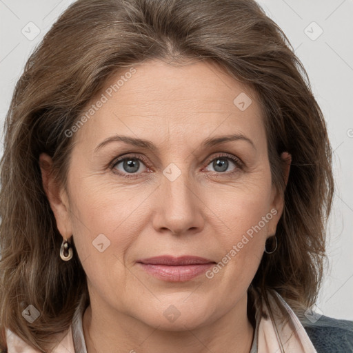 Joyful white adult female with medium  brown hair and grey eyes