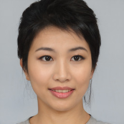 Joyful asian young-adult female with medium  black hair and brown eyes