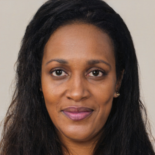 Joyful latino adult female with long  brown hair and brown eyes