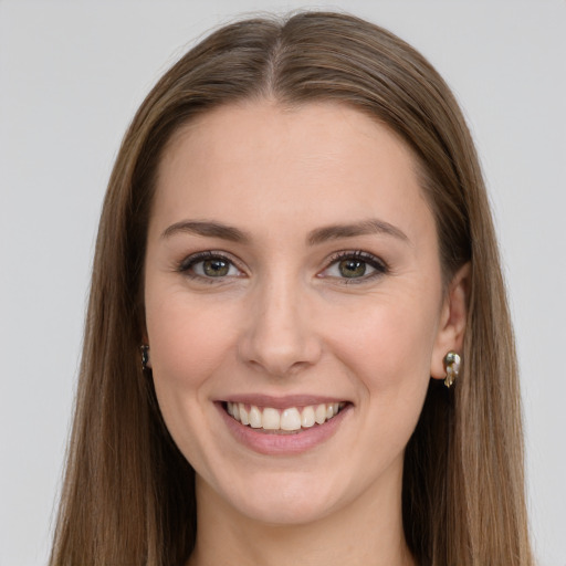 Joyful white young-adult female with long  brown hair and green eyes