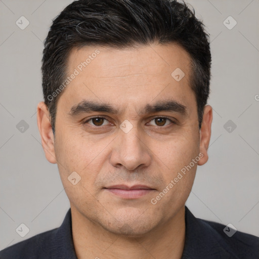 Joyful white young-adult male with short  black hair and brown eyes