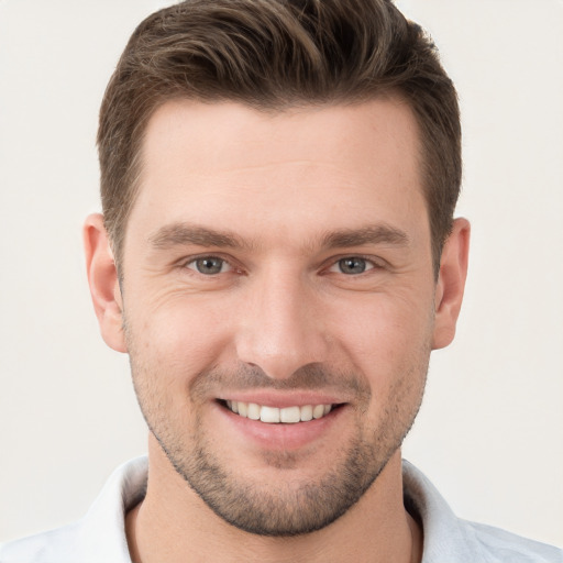 Joyful white young-adult male with short  brown hair and brown eyes