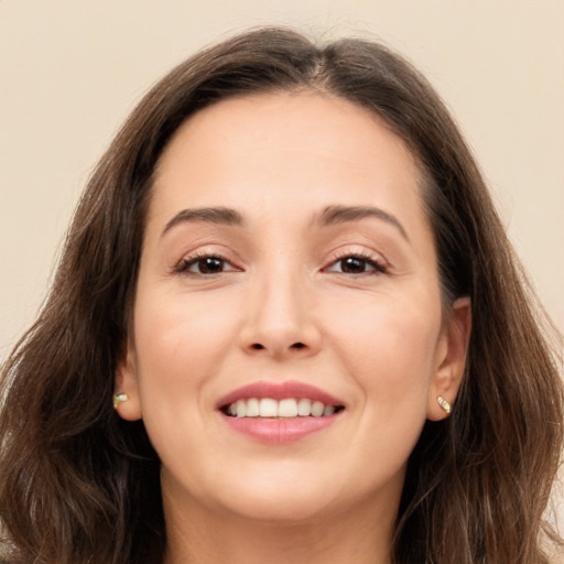 Joyful white young-adult female with long  brown hair and brown eyes