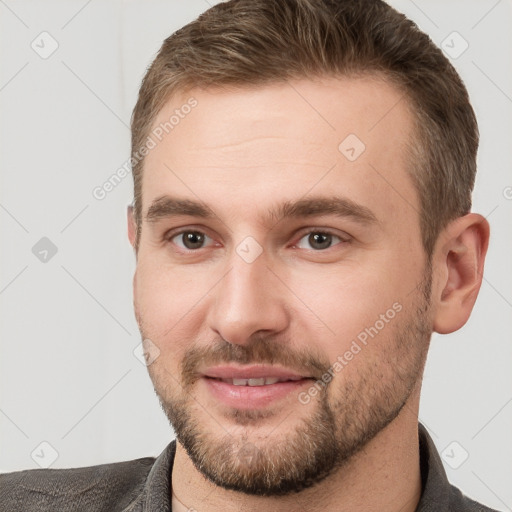 Joyful white young-adult male with short  brown hair and grey eyes