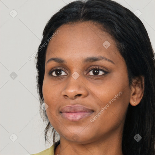 Joyful black young-adult female with long  black hair and brown eyes