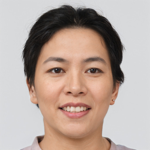 Joyful asian adult female with short  brown hair and brown eyes