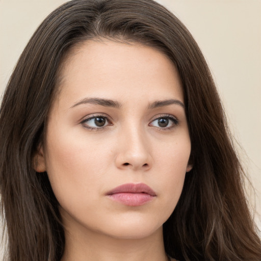 Neutral white young-adult female with long  brown hair and brown eyes