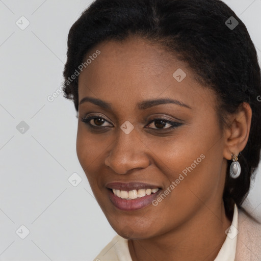 Joyful black young-adult female with short  black hair and brown eyes