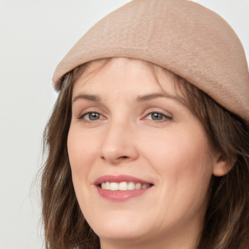 Joyful white adult female with long  brown hair and brown eyes