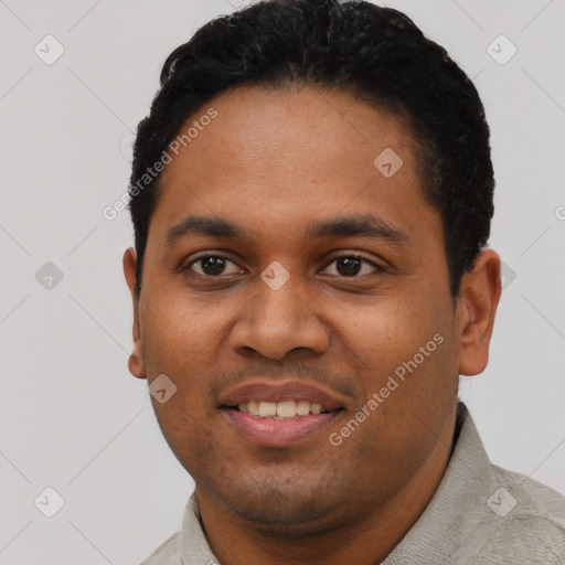 Joyful black young-adult male with short  black hair and brown eyes