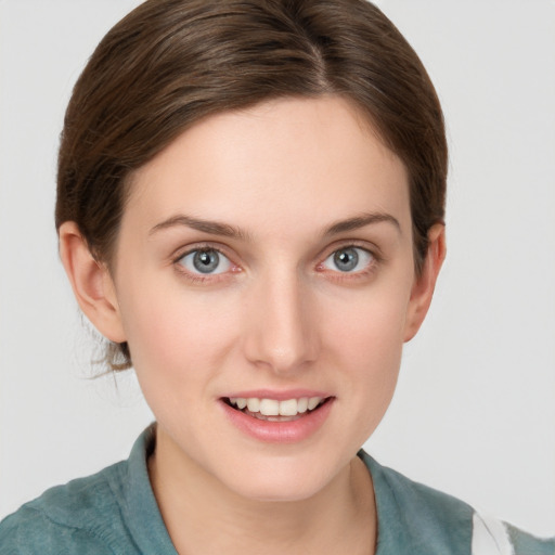 Joyful white young-adult female with medium  brown hair and grey eyes