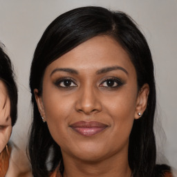 Joyful latino young-adult female with medium  brown hair and brown eyes