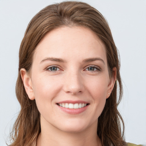 Joyful white young-adult female with long  brown hair and grey eyes