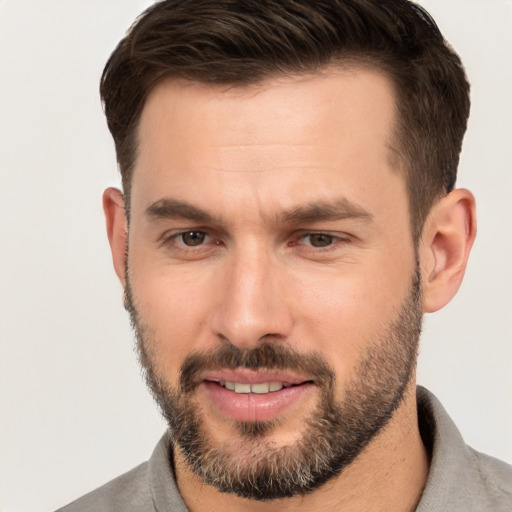 Joyful white young-adult male with short  brown hair and brown eyes