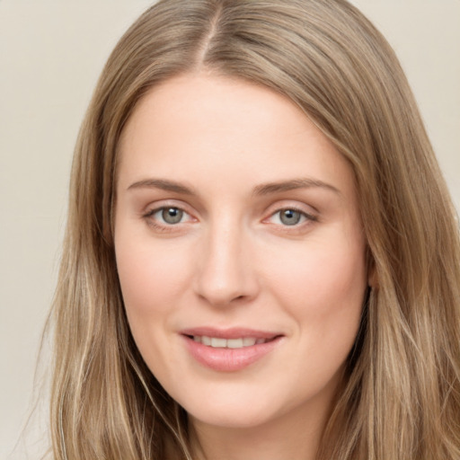 Joyful white young-adult female with long  brown hair and green eyes