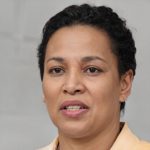 Joyful latino adult female with short  brown hair and brown eyes