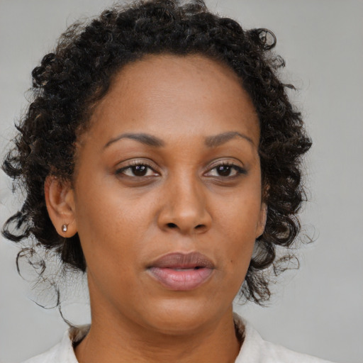 Neutral black adult female with medium  brown hair and brown eyes