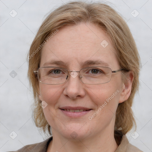 Joyful white adult female with medium  brown hair and blue eyes