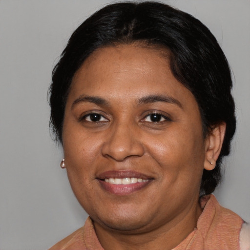 Joyful black adult female with medium  brown hair and brown eyes