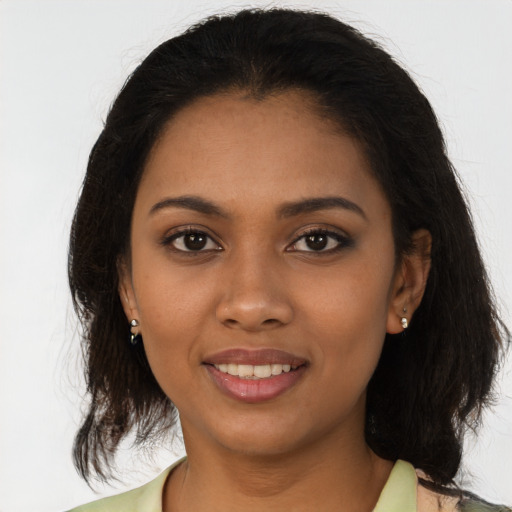 Joyful black young-adult female with medium  brown hair and brown eyes