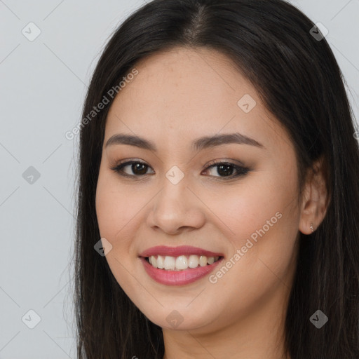 Joyful asian young-adult female with long  brown hair and brown eyes