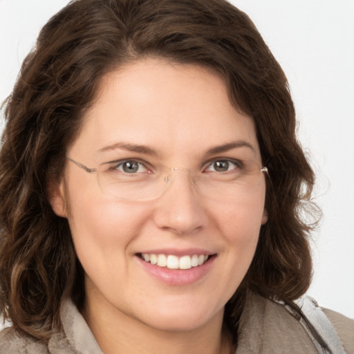 Joyful white young-adult female with medium  brown hair and green eyes