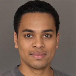 Joyful latino young-adult male with short  brown hair and brown eyes