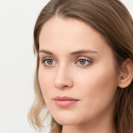 Neutral white young-adult female with long  brown hair and green eyes