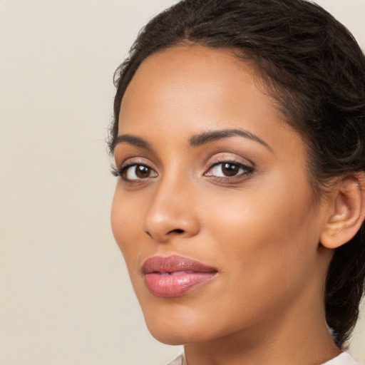 Joyful latino young-adult female with long  brown hair and brown eyes