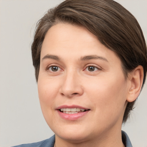 Joyful white young-adult female with medium  brown hair and brown eyes