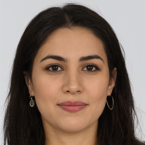 Joyful latino young-adult female with long  brown hair and brown eyes