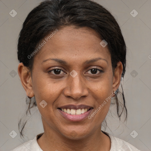 Joyful black adult female with medium  brown hair and brown eyes