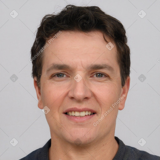 Joyful white adult male with short  brown hair and grey eyes