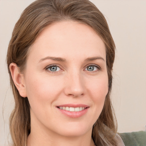 Joyful white young-adult female with long  brown hair and grey eyes