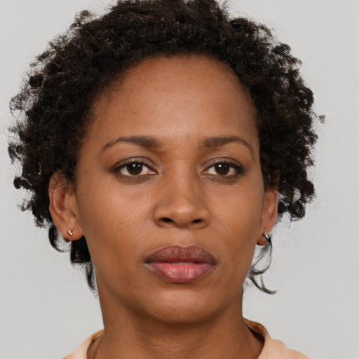 Neutral black adult female with short  brown hair and brown eyes