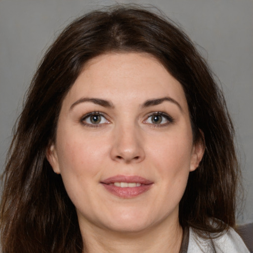 Joyful white young-adult female with medium  brown hair and grey eyes