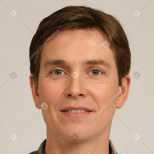 Joyful white adult male with short  brown hair and grey eyes