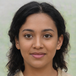 Joyful latino young-adult female with medium  brown hair and brown eyes