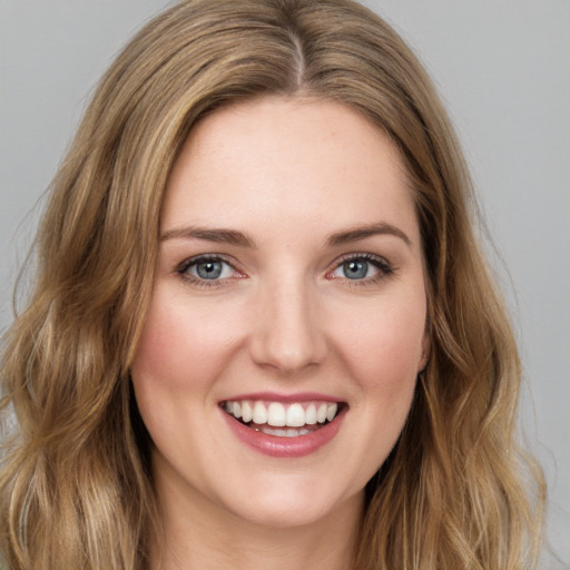 Joyful white young-adult female with long  brown hair and green eyes