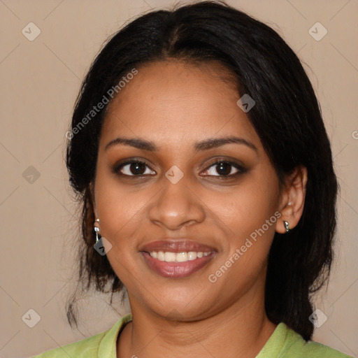 Joyful black young-adult female with long  black hair and brown eyes