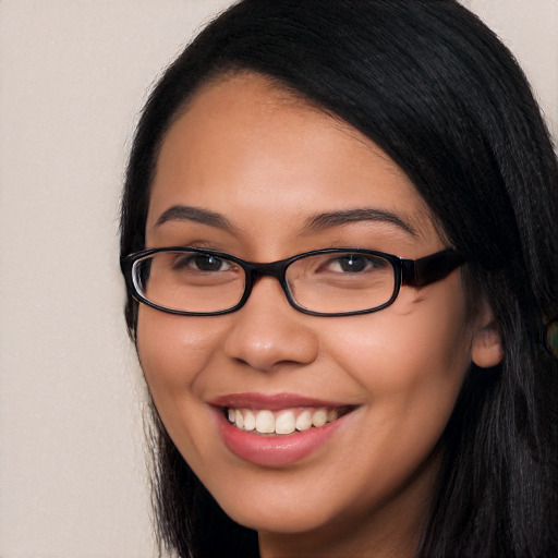 Joyful white young-adult female with long  black hair and brown eyes