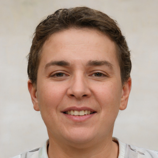 Joyful white young-adult female with short  brown hair and grey eyes