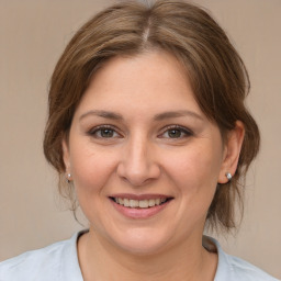 Joyful white adult female with medium  brown hair and brown eyes