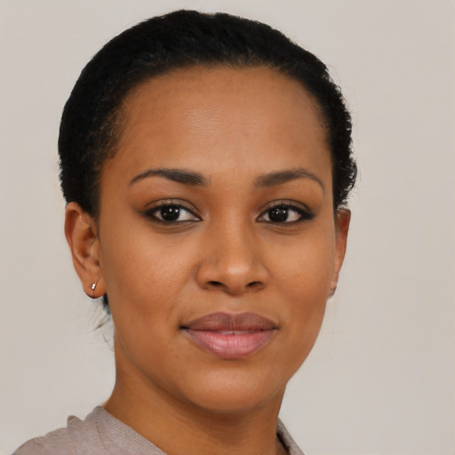 Joyful black young-adult female with short  brown hair and brown eyes