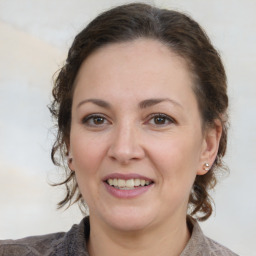 Joyful white adult female with medium  brown hair and brown eyes