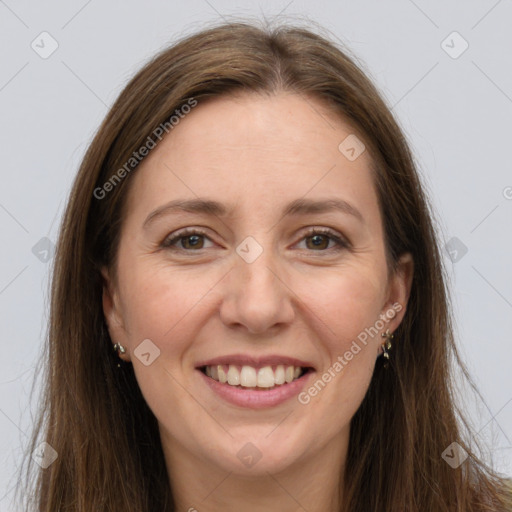 Joyful white adult female with long  brown hair and grey eyes